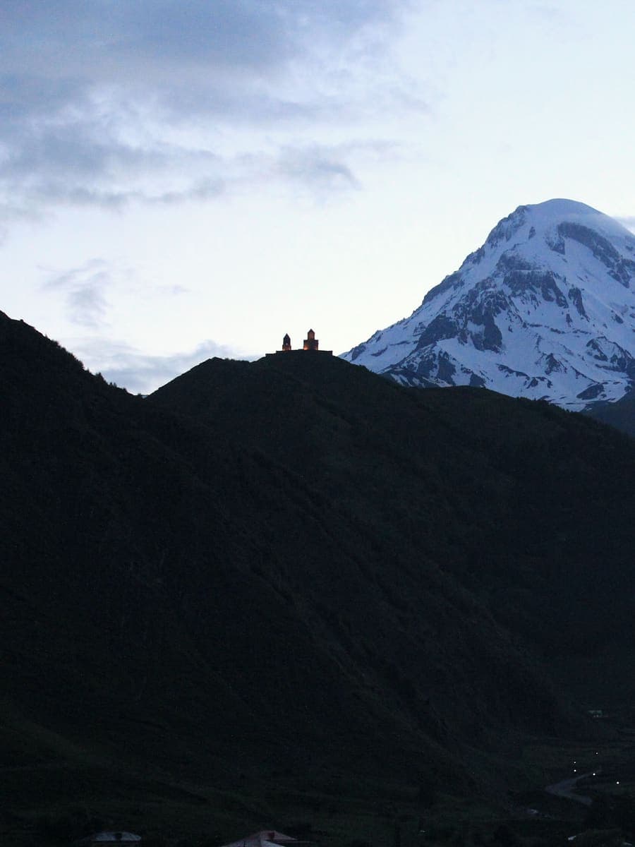 Gergeti Trinity Church on its ridge below snow-capped Mount Kazbek