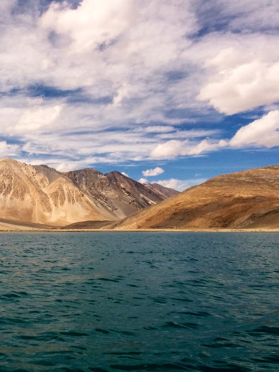 A blue lake beneath bare mountains in Ladakh