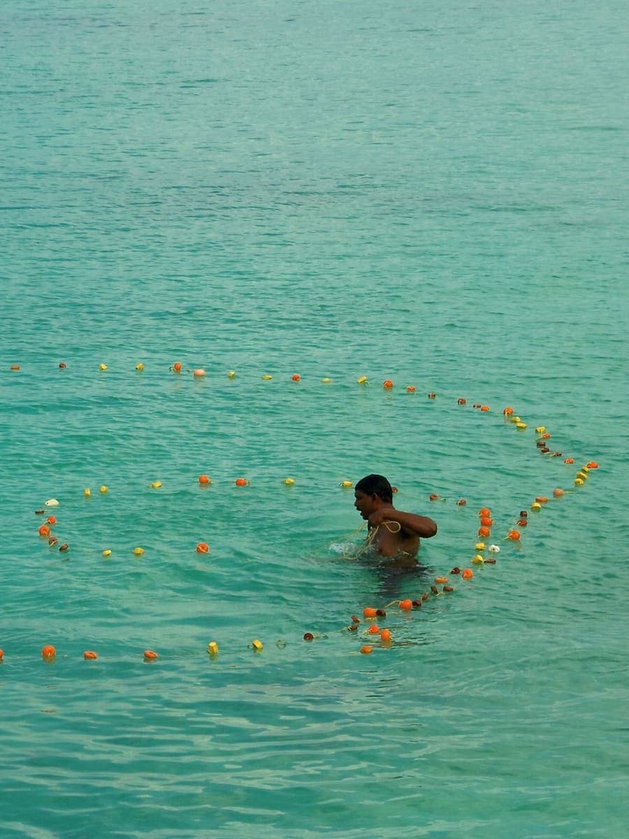 A fisherman in the turquoise lagoon of Lakshadweep