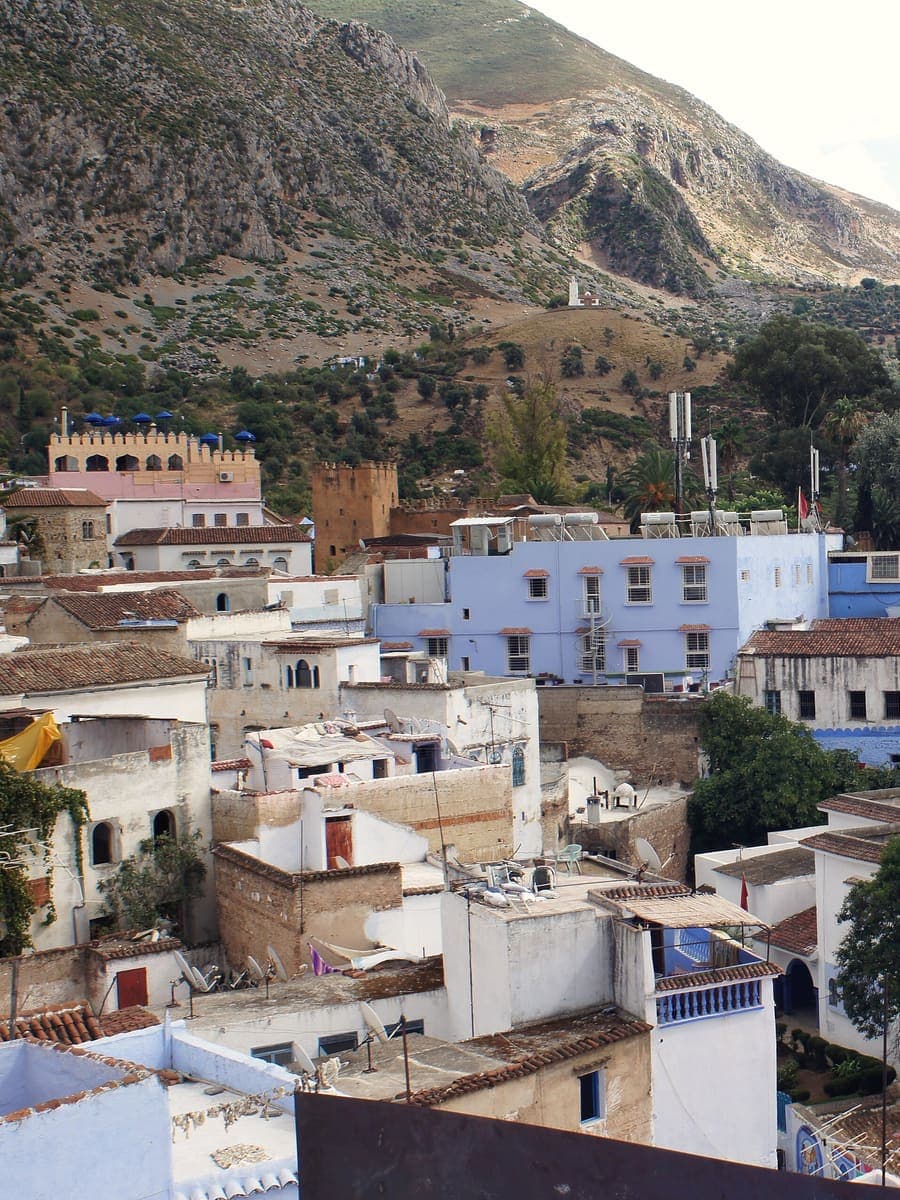 The white and blue houses of Chefchaouen below the Rif mountains, Morocco