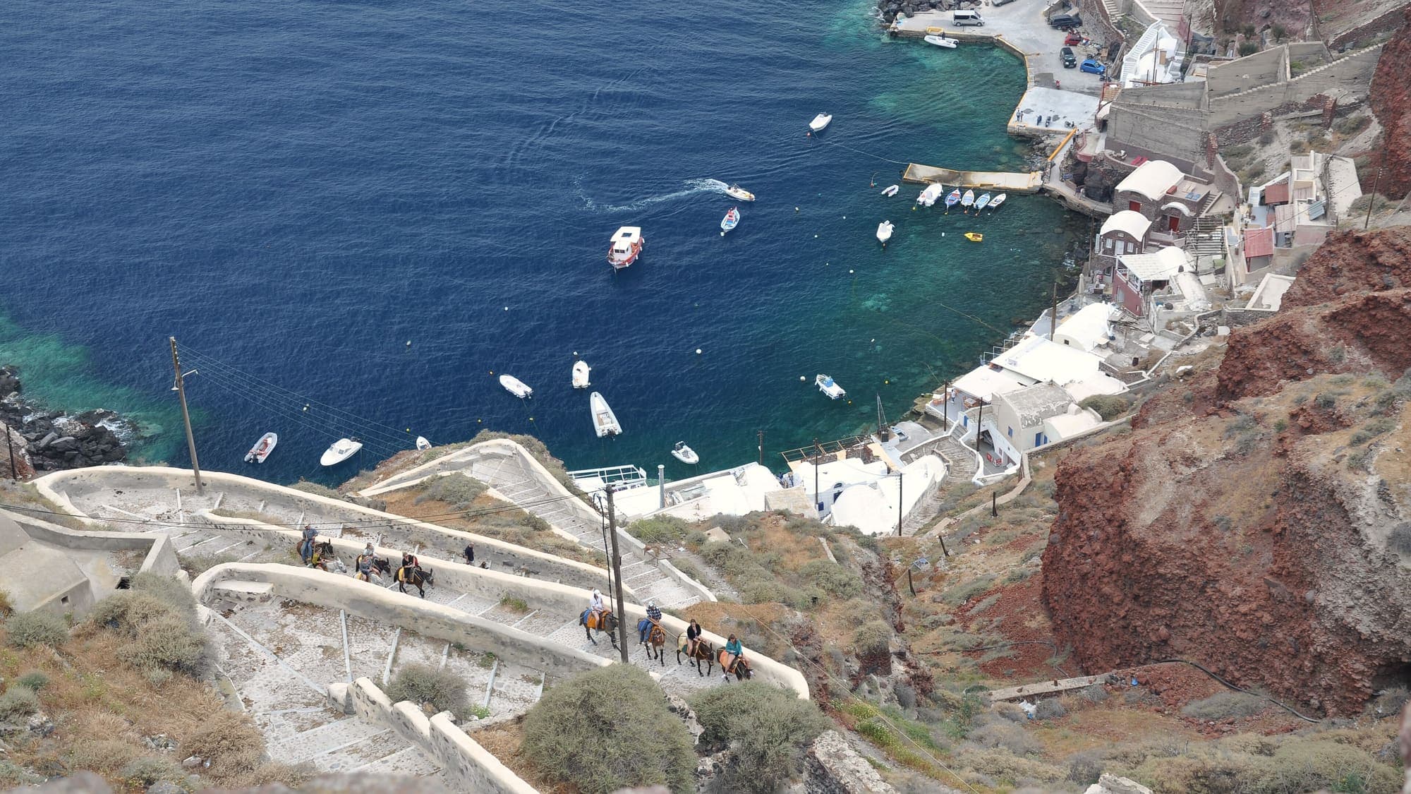 Boats in the harbour below the cliffs of Santorini