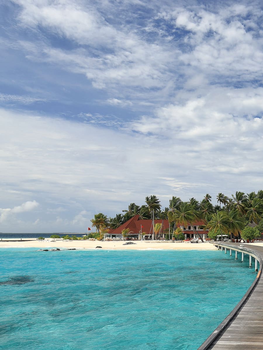 A white-sand beach and jetty on a Maldivian island